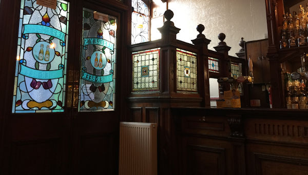 A tiny Victorian bar with stained glass screens