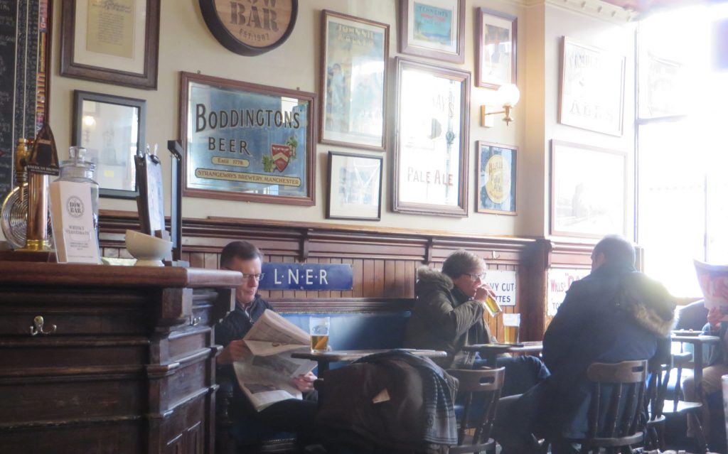Pub interior with wooden panelling, mirrors and pictures