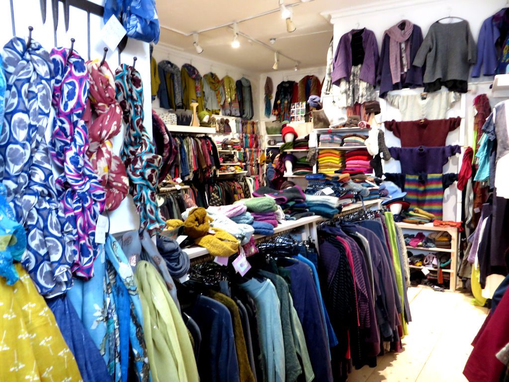 Shop interior with racks of brightly coloured woolen clothes