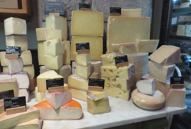 A display of cheeses, stacked high